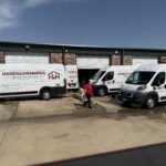 Hands & Hammers restoration vans parked at a Lewisville, TX facility, ready for emergency response.